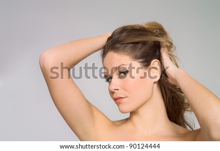 Beautiful face of young woman over neutral background