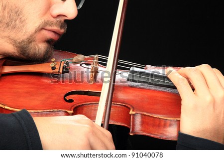 Violin player close up on black