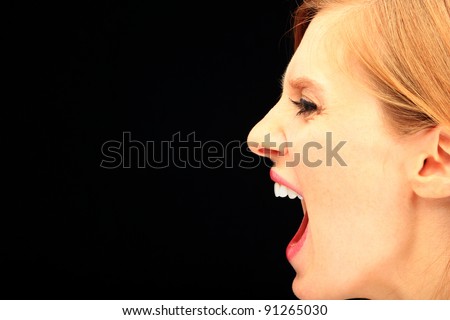 Portrait of beautiful woman profile making faces, over black background