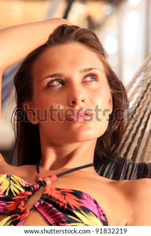 woman lounging in hammock at summer lounge