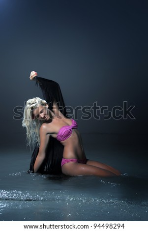 Beautiful blonde in the water under moon light
