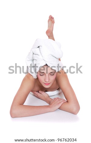 Young woman wrapped towel isolated on white background