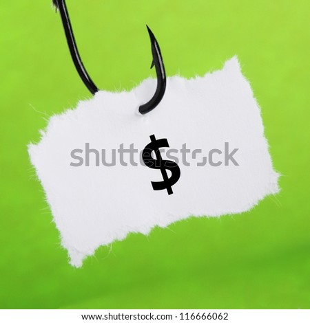 paper note on fishing hook on green background