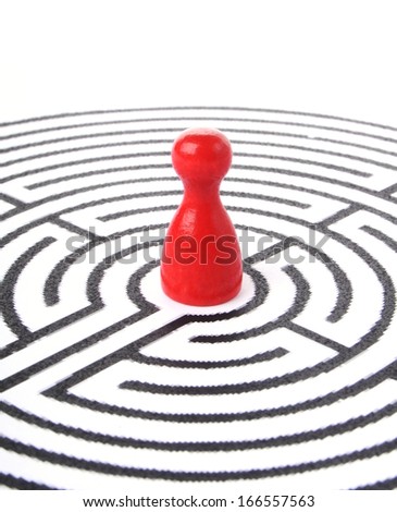 red wooden figure lost in a labyrinth