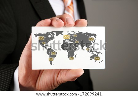 businessman holding a business card with his emails correspondence to his cooperation partners
