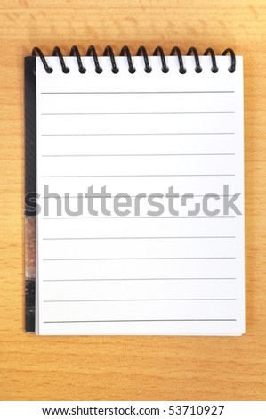 blank page from a notebook of a brown desk