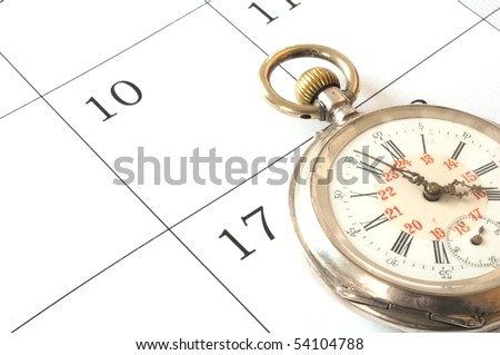 a old pocket watch isolated on calendar