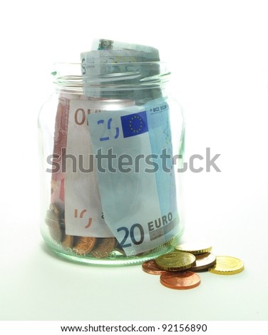 tip jar with bills and coins on white background