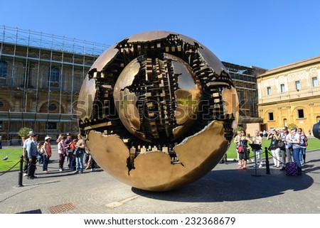 VATICAN - OCTOBER 18: People around Sphere in Courtyard of the Pinecone at Vatican Museums at October 18, 2014. Sphere was created in 1990 by Italian sculptor Arnoldo Pomodoro.