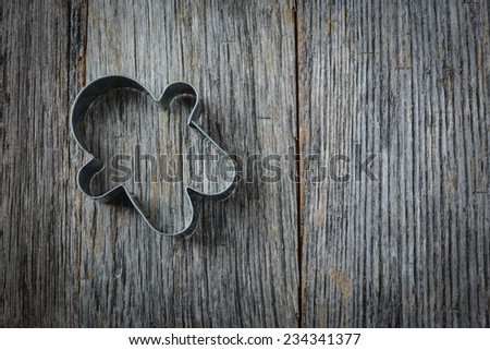 Gingerbread Man Cookie Cutter on Rustic Wood Background