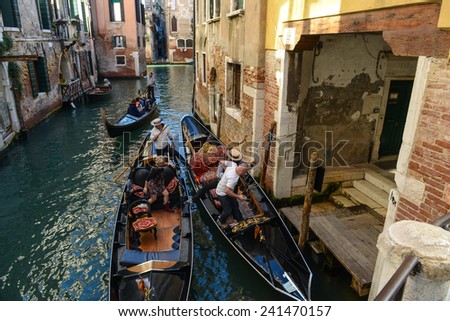 VENICE, ITALY - OCTOBER 22: Gondolier the Grand Canal on October 22, 2014 in Venice, Italy. Gondolas are traditional Venetian rowing boats, well suited to the conditions of the Venetian lagoon
