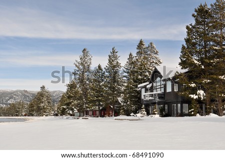 Cabin in Snow with Mountains in Background