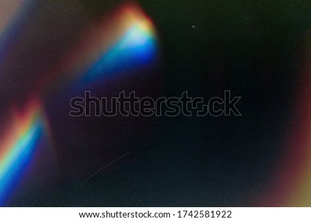 Designed film texture background with heavy grain, dust and a light leak Real Lens Flare Shot in Studio over Black Background. Easy to add as Overlay or Screen Filter over Photos overlay Foto stock © 