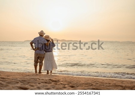 Similar – Image, Stock Photo Romantic couple walking on foamy sea waves