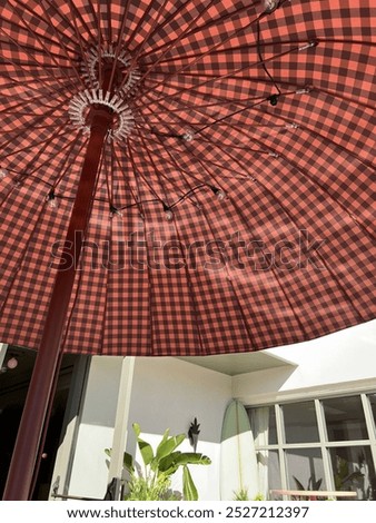 Similar – Image, Stock Photo A checkered umbrella in the shop window, a parked red car reflected in the sunlight.