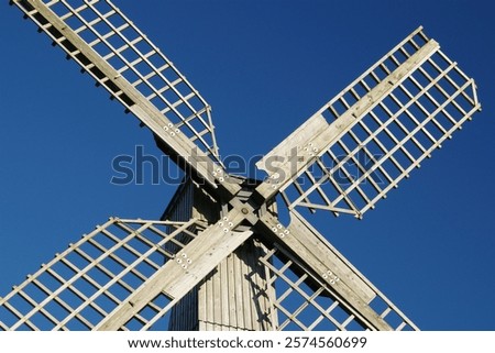 Similar – Image, Stock Photo Windmill at the lower edge of the picture in silhouette form and sky with contrails