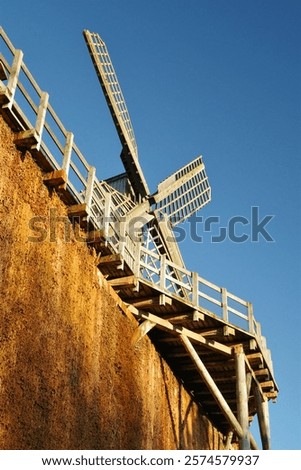 Similar – Image, Stock Photo Windmill at the lower edge of the picture in silhouette form and sky with contrails