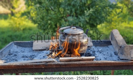 Similar – Image, Stock Photo Kettle placed on campfires in snowy woods at sundown