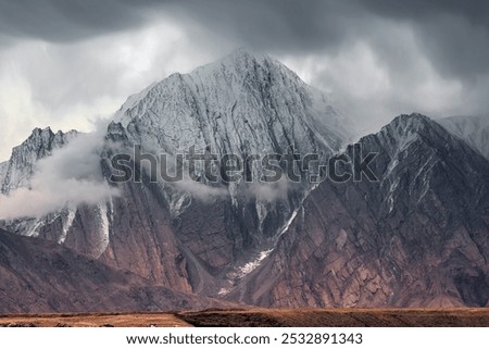 Similar – Foto Bild Schroffer Berggipfel eingehüllt in dunkle Wolken