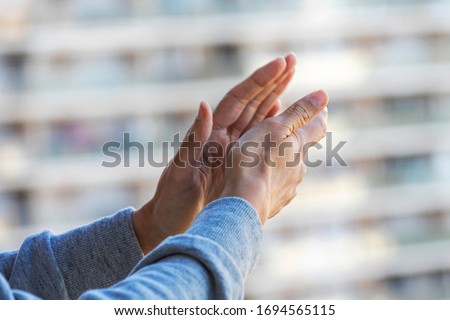 Woman hands applauding medical staff from their balcony. People in Spain clapping on balconies and windows in support of health workers, doctors and nurses during the Coronavirus pandemic