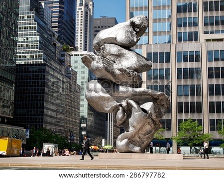 NEW YORK, NY - MAY 14, 2015: Urs Fisher\'s new art installation, Big Clay #4, stands on the plaza at 345 Park Ave. in the midst of skyscrapers and busy midday foot traffic.