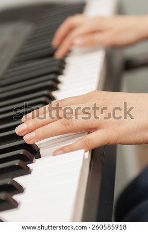 Hands of the musician on the piano keys