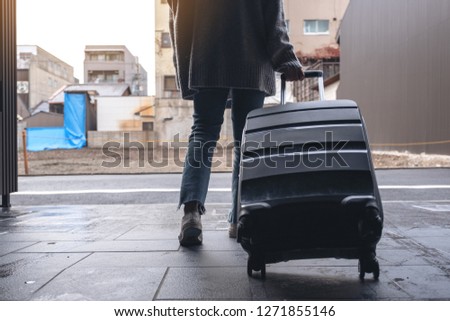Similar – Image, Stock Photo A young woman leaving the airport with her luggage at her destination