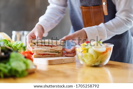 Similar – Image, Stock Photo Preparing a ham salad with rice to take away. The containers used are compostable.