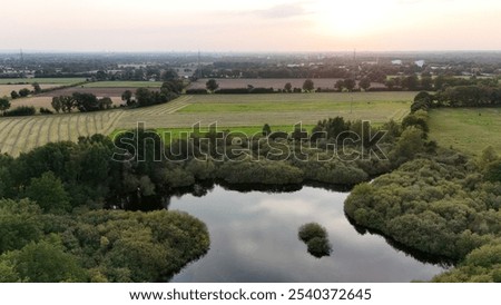 Similar – Foto Bild Ackerland umgeben von grünen Bäumen