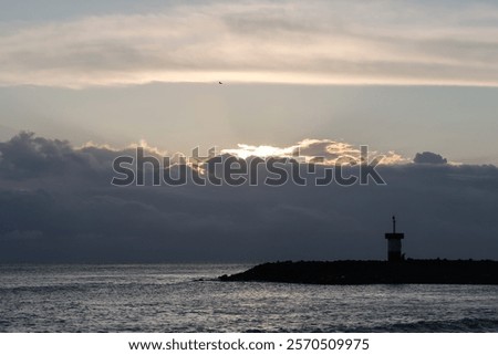 Similar – Foto Bild Die Sonne verschwindet hinter den Bäumen. Hinter dem Haus ist es schon dunkel. Eine starke Bewölkung gibt dem ganzen ein prächtiges Panorama.