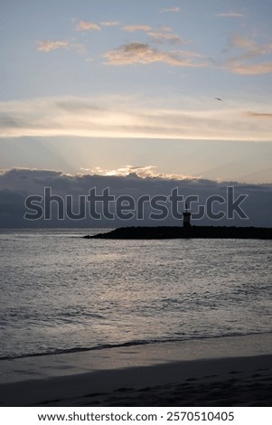 Similar – Foto Bild Die Sonne verschwindet hinter den Bäumen. Hinter dem Haus ist es schon dunkel. Eine starke Bewölkung gibt dem ganzen ein prächtiges Panorama.