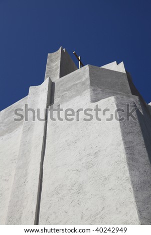 An Art Deco church steeple set against a blue, cloudless-sky