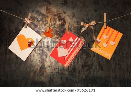 hand made valentine\'s cards hanging on a string