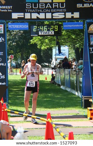 60 plus category event, crossing the finish line in a sprint event.