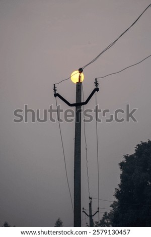 Similar – Image, Stock Photo surreal | power pole in morning light as reflection in a puddle