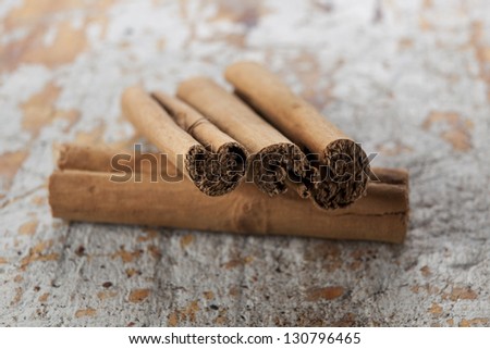 Cinnamon scrolls on a distressed wood background.