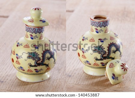Traditional Chinese porcelain sauce bottle on wood background.