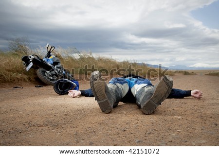 Man on ground after a motorcycle accident