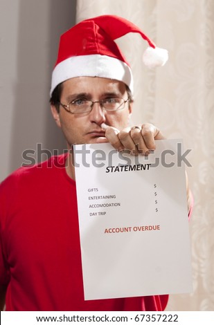 Caucasian man looking at the disastrous Xmas budget and expenses.