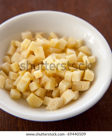 Small bowl full of diced ginger as used in Thai cooking.