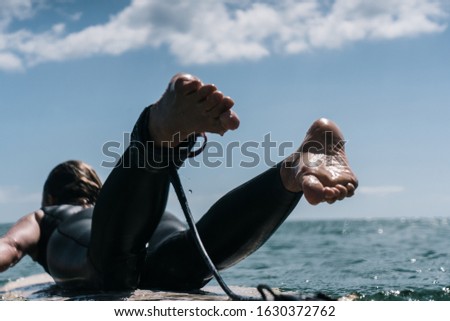 Similar – Image, Stock Photo Surfer woman with wetsuit and surfboard looking at the sea