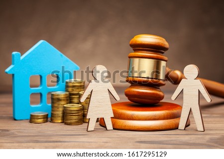Divorce by law. Division of property after a divorce. The husband is trying to sue his wife for property under the law. A woman with a house and money, and a man with a hammer of a judge.