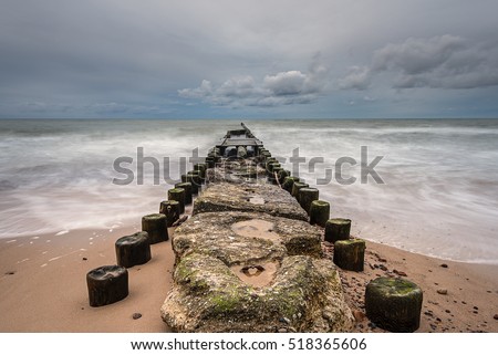 Old wooden breakwater on pebble beach in Wicie,  a small and charming village between Darlowo and Jaroslawiec. Stormy day on Baltic Sea. Poland. Europe. Zdjęcia stock © 