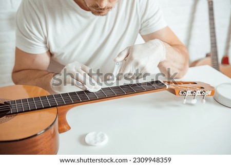 Similar – Image, Stock Photo Craftsman tuning string instrument in workshop