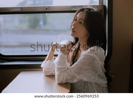 Similar – Image, Stock Photo Pensive woman traveler sitting near calm lake