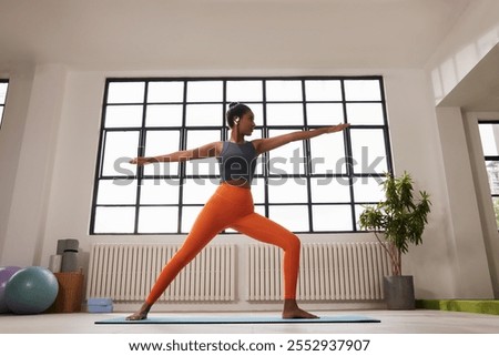 Similar – Image, Stock Photo Focused athletes practicing yoga together performing supported shoulderstand balance position in contemporary gym