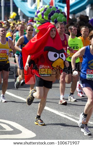 LONDON, UK - APR. 22: A man dresses in fancy dress as tens of thousands of people pass Tower Bridge during the London Marathon on the Apr 22, 2012 in London, UK
