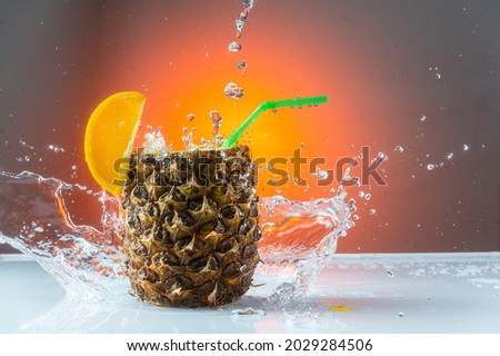 Splashing water around the pineapple. Pineapple cocktail and splash. Red background. Stok fotoğraf © 