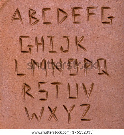 letters carved on clay
