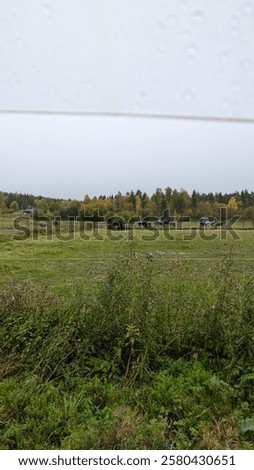 Similar – Foto Bild Ländliches Feld unter bewölktem Himmel mit Sonnenstrahlen